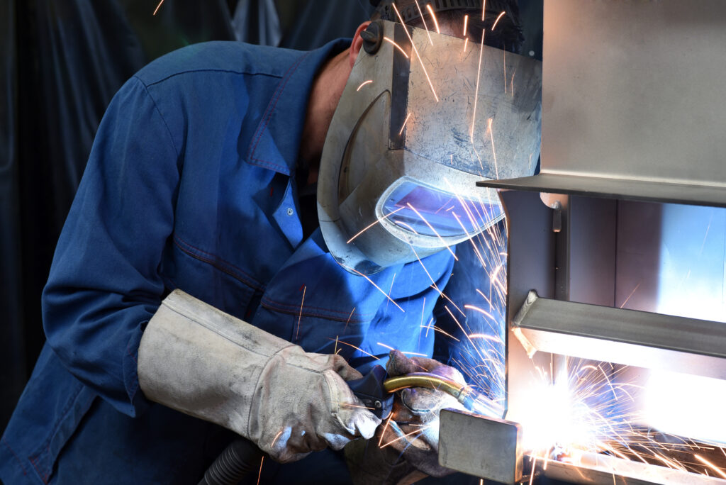 welder works in metal construction - construction and processing
