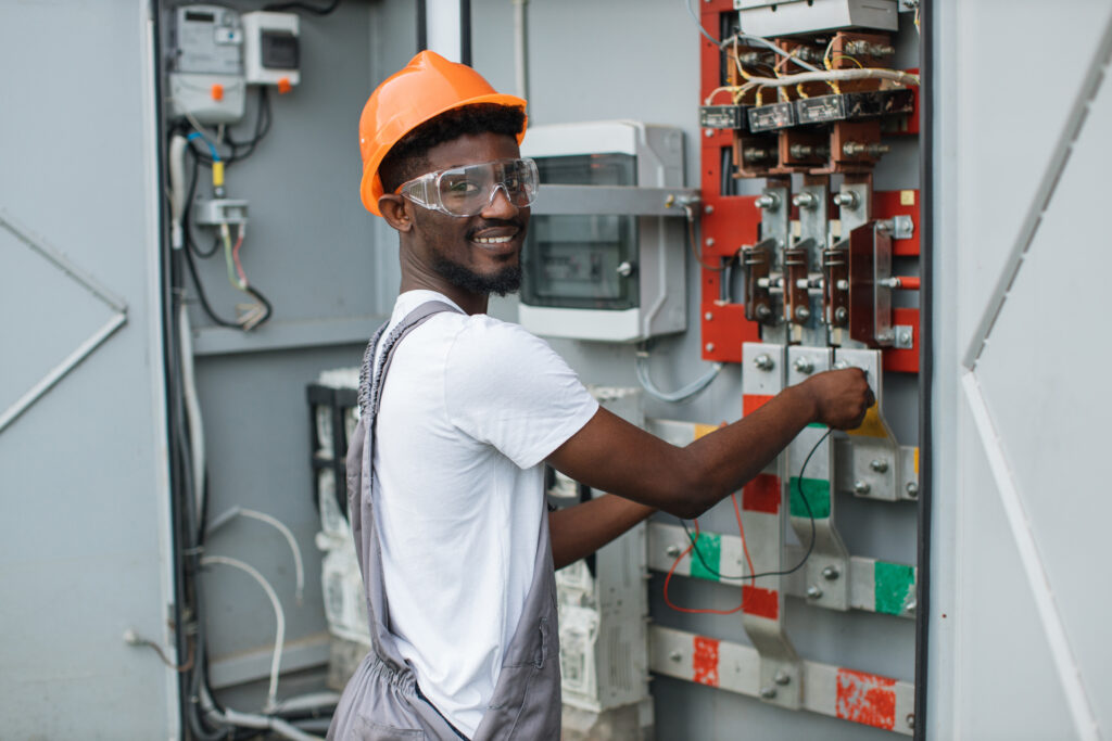 Technician examining switchgear on solar station